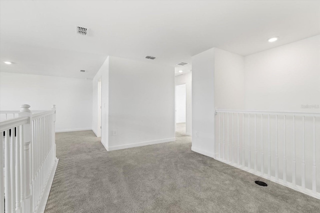 unfurnished room with light carpet