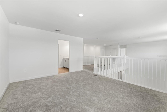 unfurnished room featuring light colored carpet