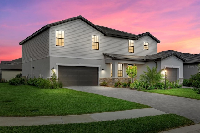 view of front facade featuring a lawn and a garage