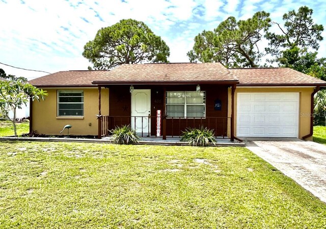 ranch-style house featuring a garage and a front yard