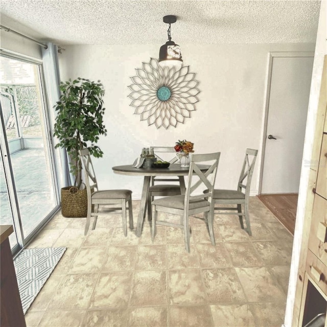 dining space featuring a textured ceiling