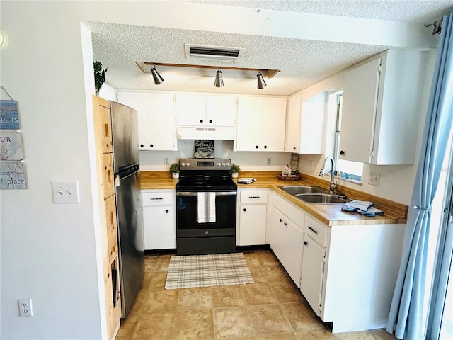 kitchen featuring range with electric cooktop, sink, white cabinets, and stainless steel refrigerator