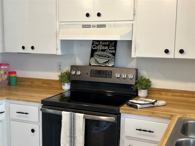 kitchen with range with electric cooktop, white cabinetry, under cabinet range hood, and wood counters