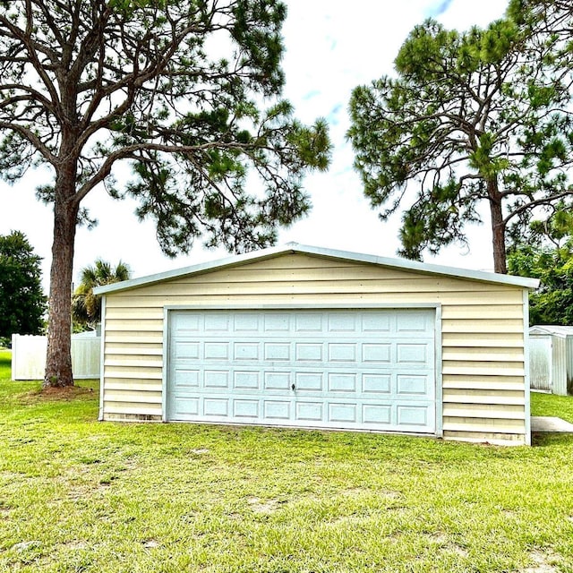 detached garage featuring fence