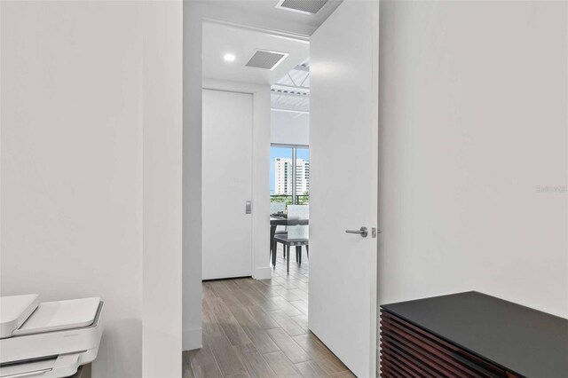 corridor featuring hardwood / wood-style floors