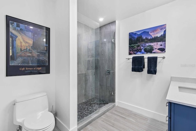 bathroom with vanity, a tile shower, and toilet