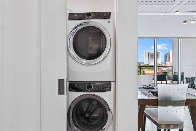 laundry room featuring stacked washing maching and dryer