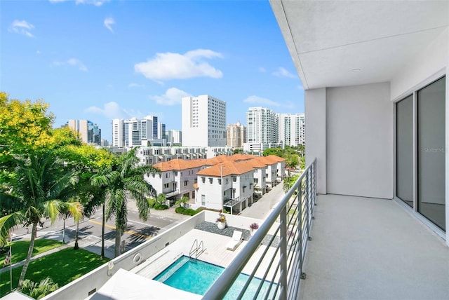 balcony with a fenced in pool