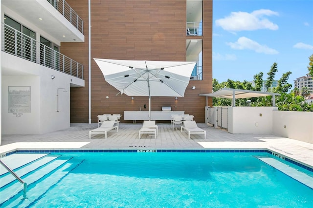 view of pool with an outdoor living space and a patio area