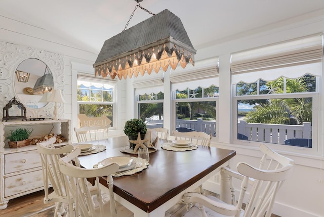 dining space with hardwood / wood-style floors and vaulted ceiling