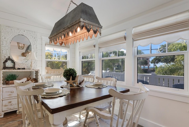 dining space featuring hardwood / wood-style floors and lofted ceiling