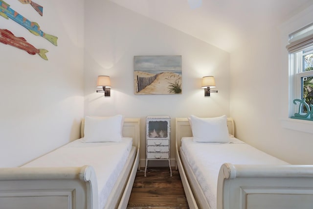 bedroom featuring dark hardwood / wood-style flooring and lofted ceiling