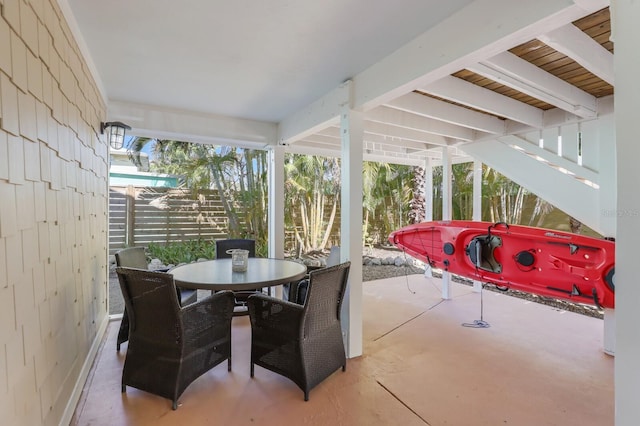 sunroom featuring beam ceiling