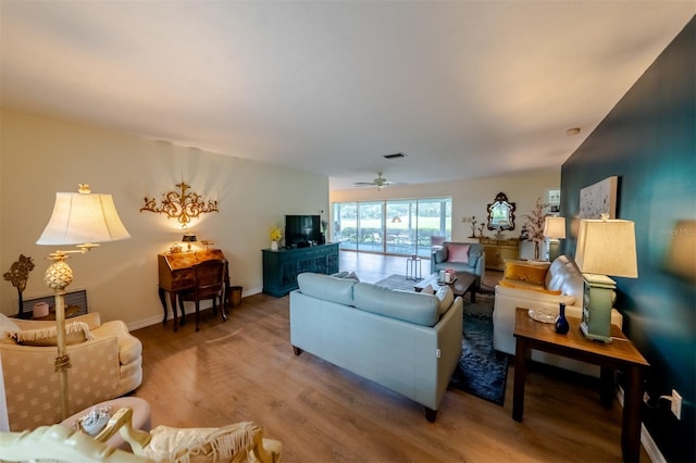 living room featuring hardwood / wood-style flooring and ceiling fan