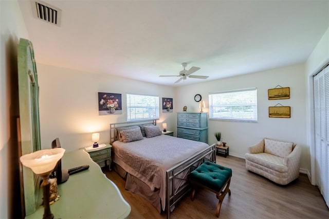 bedroom featuring a closet, hardwood / wood-style floors, and ceiling fan