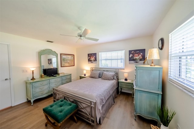 bedroom featuring light hardwood / wood-style flooring and multiple windows