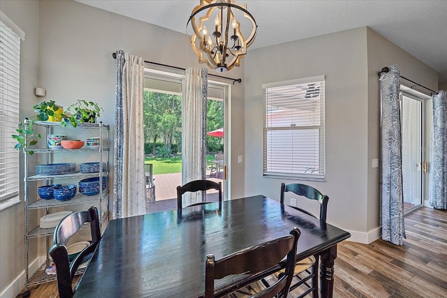 dining space featuring a chandelier and wood-type flooring