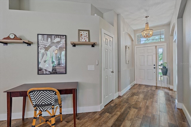 foyer with a chandelier and dark hardwood / wood-style floors