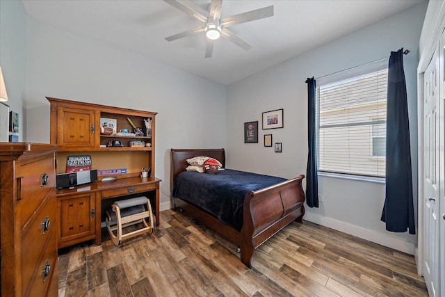 bedroom featuring ceiling fan, dark hardwood / wood-style floors, and a closet