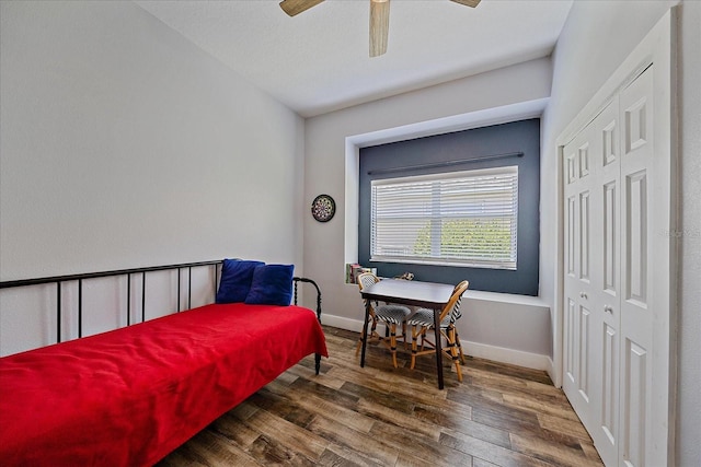 bedroom with ceiling fan, a closet, and dark wood-type flooring