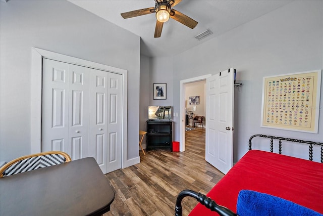 bedroom with a closet, ceiling fan, and dark wood-type flooring