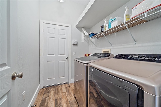 laundry area featuring separate washer and dryer and hardwood / wood-style flooring