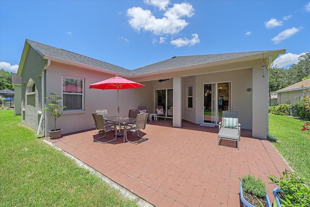 back of house with a yard, ceiling fan, and a patio area