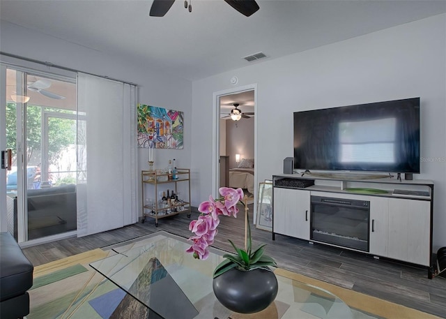 living room featuring ceiling fan and hardwood / wood-style flooring