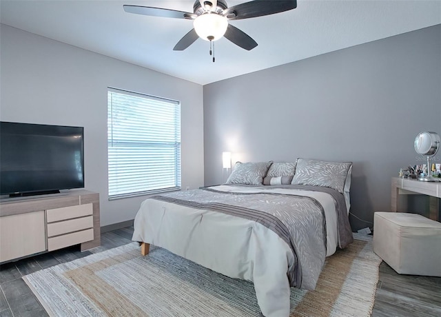 bedroom with ceiling fan and wood-type flooring