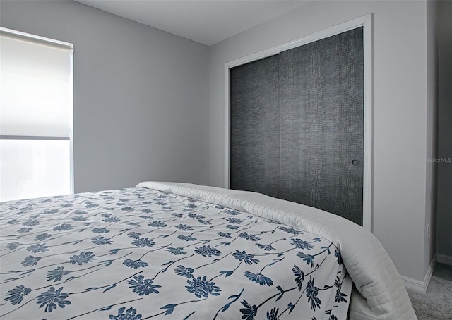 carpeted bedroom with a closet