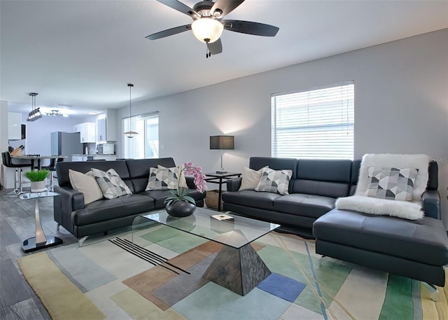 living room with ceiling fan and hardwood / wood-style floors