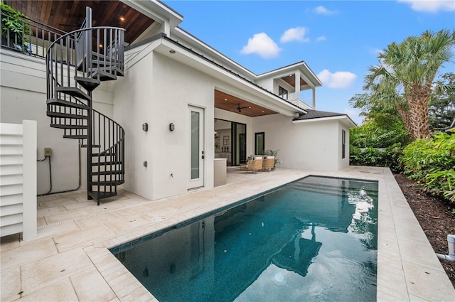 rear view of property with a patio area and ceiling fan