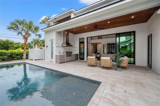 back of house with an outdoor kitchen, a patio, and ceiling fan