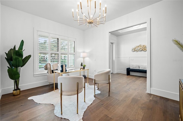 office area with dark hardwood / wood-style floors and an inviting chandelier