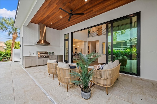 view of patio featuring an outdoor kitchen, ceiling fan, sink, and grilling area