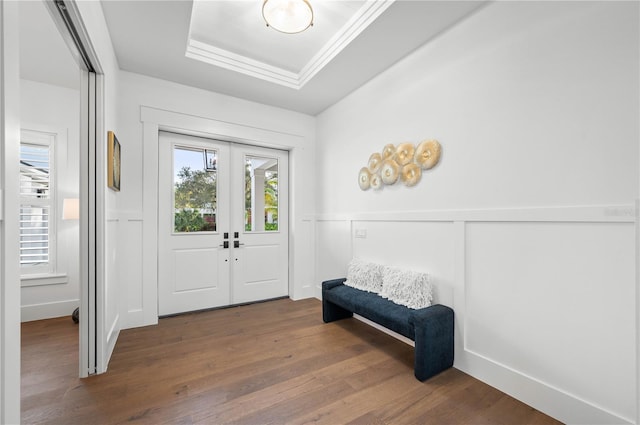 entryway featuring hardwood / wood-style flooring, crown molding, a tray ceiling, and french doors