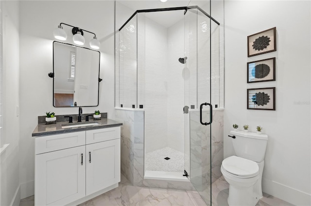 bathroom featuring vanity, toilet, and a shower with door