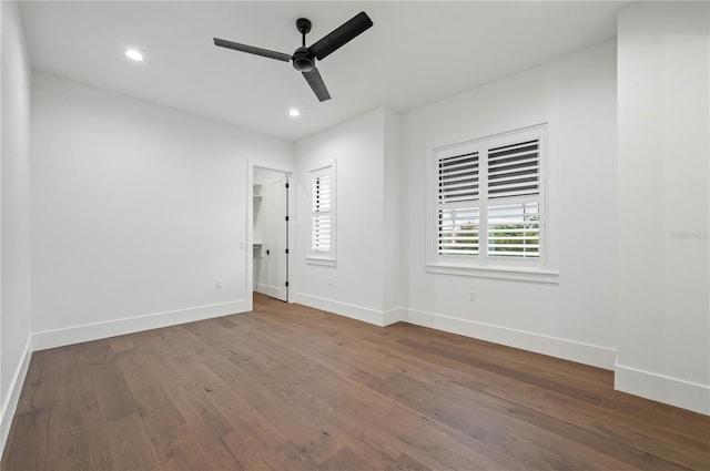 spare room featuring wood-type flooring and ceiling fan