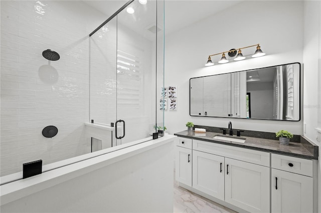 bathroom featuring vanity and an enclosed shower