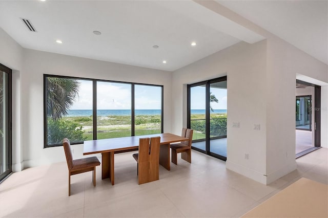 tiled dining room with a water view