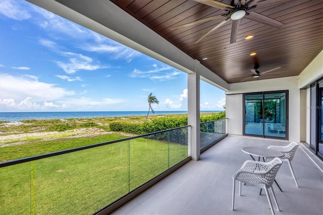 unfurnished sunroom featuring a water view, ceiling fan, and wooden ceiling