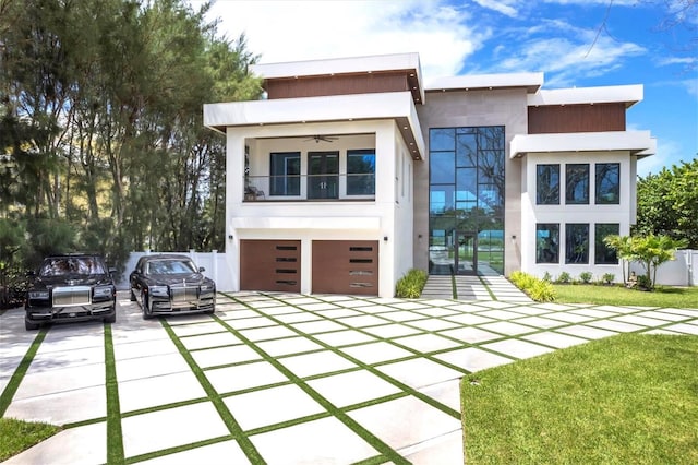 contemporary home with a front lawn and a garage