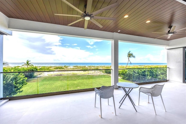 sunroom with wooden ceiling and a water view