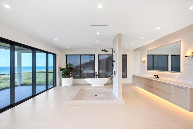 bathroom with tile patterned floors, vanity, a water view, and separate shower and tub