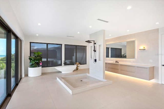 bathroom featuring plus walk in shower, tile patterned flooring, and vanity