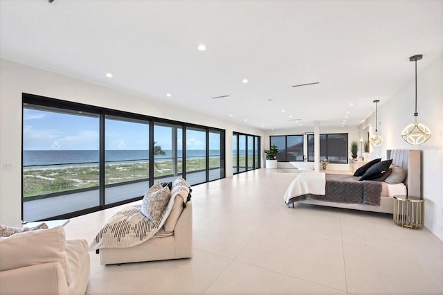 bedroom featuring multiple windows, a water view, and light tile patterned flooring