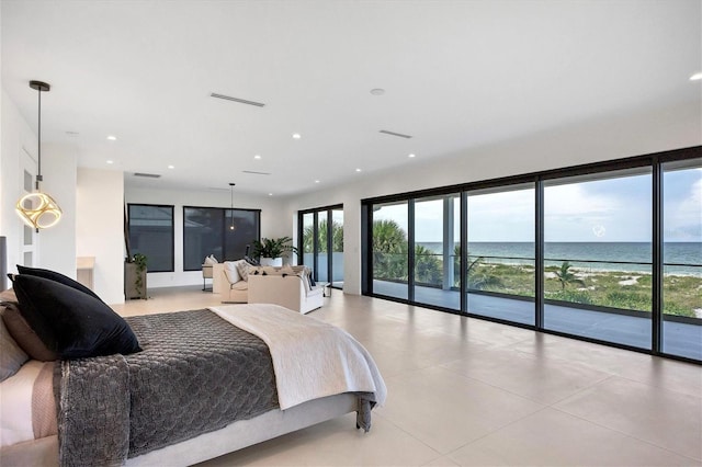 bedroom featuring access to exterior, a water view, and multiple windows