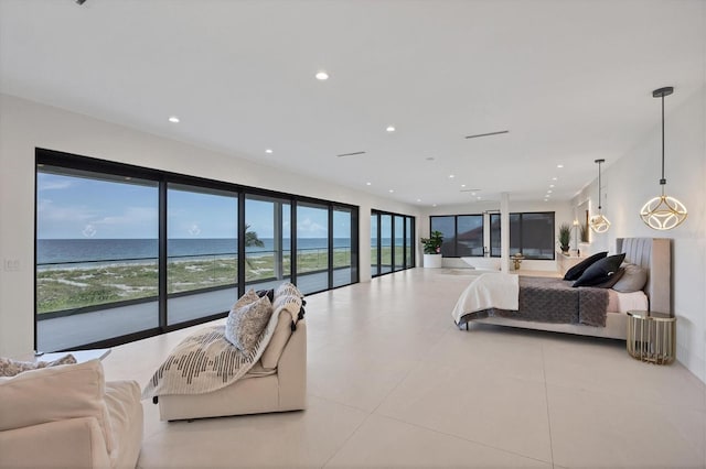 bedroom with light tile patterned floors and a water view