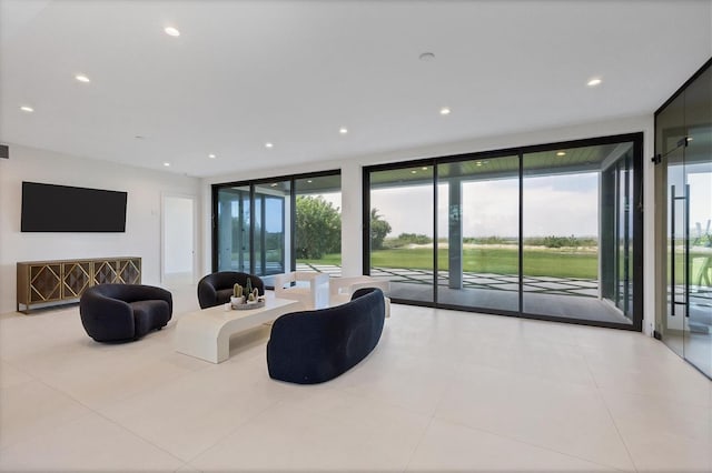 living room featuring light tile patterned floors and floor to ceiling windows