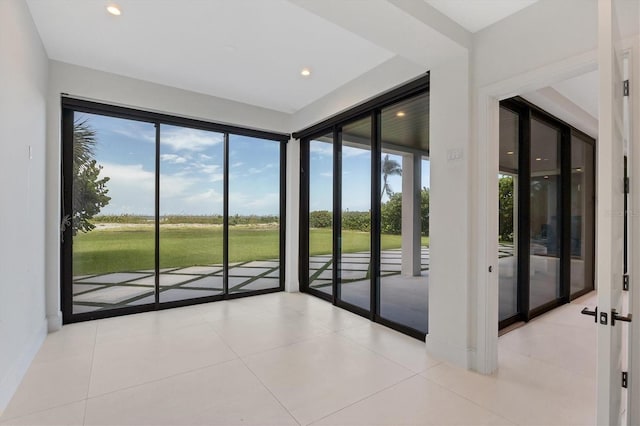 interior space with light tile patterned floors and french doors